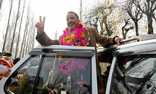 Salman Sagar, National Conference candidate for the state Urban Local Bodies (ULB) polls celebrates after he won a ULB seat outside a counting center in Srinagar on Tuesday.
