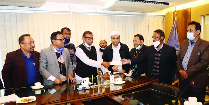 Sylhet City Corporation Mayor Ariful Haque Chowdhury hands over a cheque for Tk 5.68 crore as outsnading electricity bill to the officials of four division of Bangladesh Power Development Board at his office yesterday.