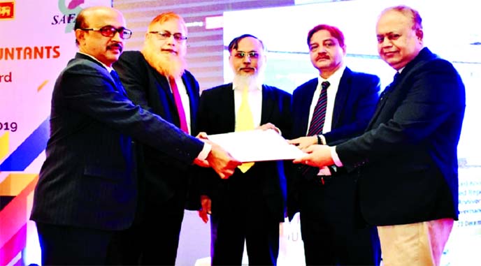 ICAB President Muhammad Farooq along with SAFA Vice President AKM Delwer Hussain and former ICAB President Mohammed Humayun Kabir handing over the "Certificate of Merit" award to Md. Zakir Hossain, Deputy Managing Director of Investment Corporation of B