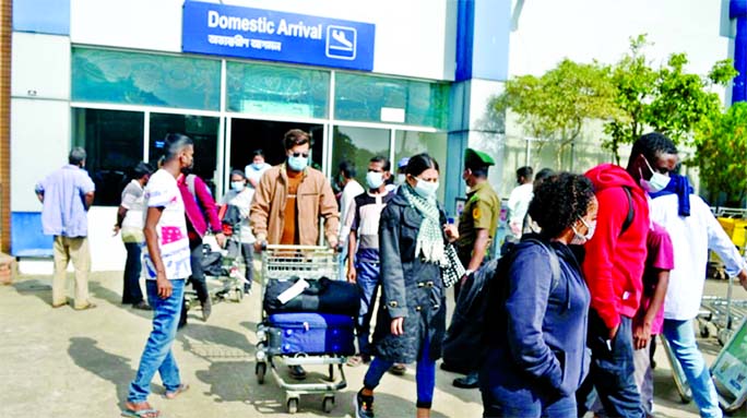 Bangladeshi expatriates are seen coming out from Osmani International Airport in Sylhet on Thursday upon their arrival from the United Kingdom amid panic over a new variant of coronavirus there.