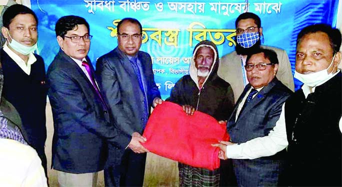 Ahmed Sadrul Alam, General Manager of Janata Bank, distributes blanket among the cold-hit people at the bank's Sylhet Divisional Office on Wednesday night.