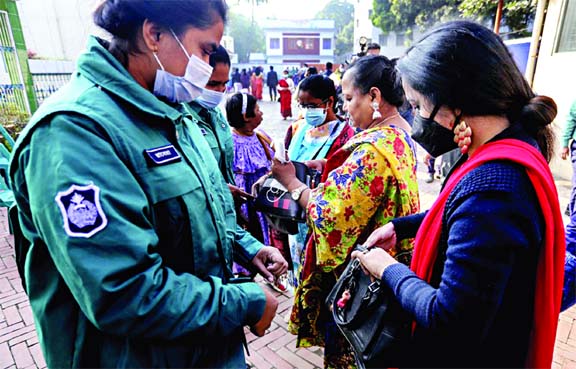 Law enforcers check bags of people at the entrance of churches as security measures beefed up on the occasion of Christmas Day. The snap was taken from in front of a church in the city's Tejgaon on Friday.