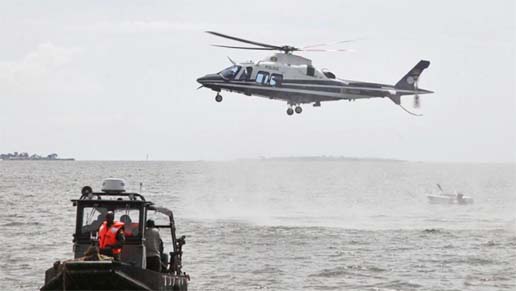 A helicopter searches for victims of a boat which capsized in Lake Victoria near the capital, Kampala, Uganda.