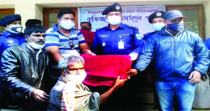 Md Mohibul Islam Khan, the outgoing SP of Kurigam, distributes blanket among the cold-hit people at a ceremony in the Bhurungamari upazila auditorium of Kurigram district on Saturday under the slogan of "Togetherness is Our Strength."
