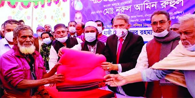 Advocate Nurul Amin Ruhul, MP, distributes blanket among the cold-hit people at a function held at Oxford International School premises in Sadullahpur union under Matlab Uttar Upazila in Chandpur district.