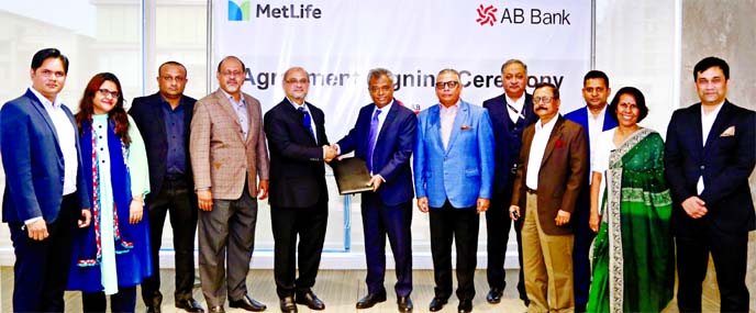 Tarique Afzal, Managing Director of AB Bank Limited and Asif Shams, Director of MetLife, exchanging an agreement signing document at the bank head office in the city on Monday. Under the deal, bank's Nishchinto Fixed Deposit Account holders will enjoy Li