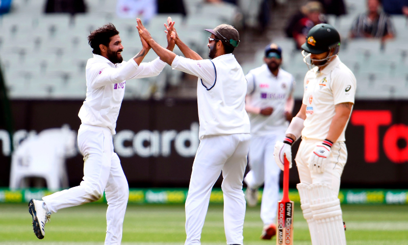 India Ravi Jadeja (left) and Ajinkya Rahane (center) celebrate the dismissal of Australia's Matthew Wade on the third day of the second cricket Test match between Australia and India at the MCG in Melbourne on Monday.