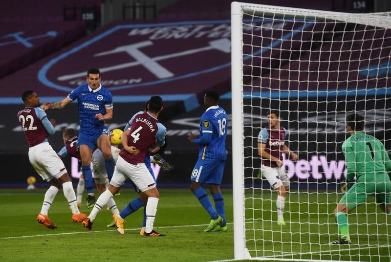 Brighton's defender Lewis Dunk (third left) controls the ball in the build-up to scoring their second goal during the English Premier League football match between West Ham United and Brighton and Hove Albion at The London Stadium, in east London on Sund