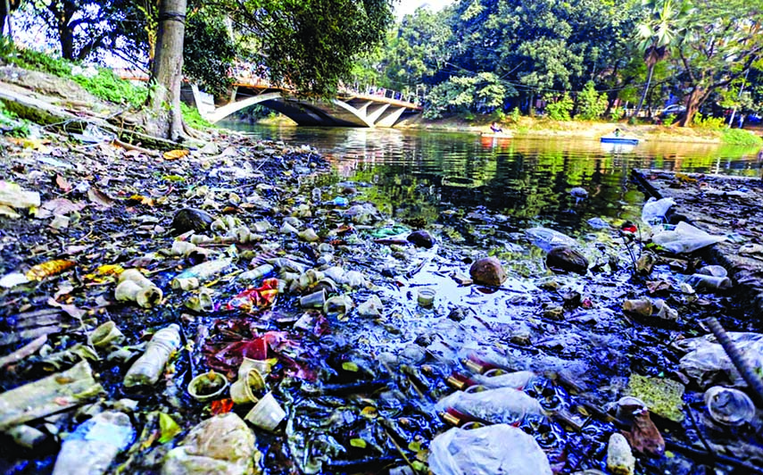 Garbage covers a large part of Dhanmondi Lake in the capital city due to mindless dumping of waste by neighbouring residents. This photo was taken from 8 No Dhanmondi Lake Road on Monday.