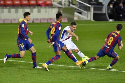 Eibar's forward Sergi Enrich (center) challenges Barcelona's defender Clement Lenglet (left), Barcelona's defender Junior Firpo (second left) and Barcelona's midfielder Miralem Pjanic (right) during the Spanish League football match at the Camp Nou st