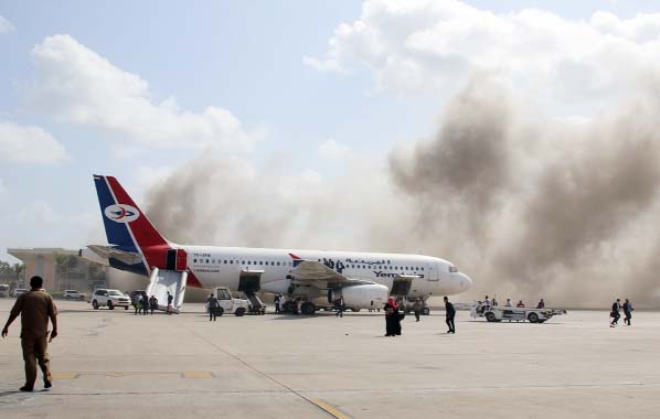 Dust rises after explosions hit Aden airport, upon the arrival of the newly-formed Yemeni government in Aden, Yemen.