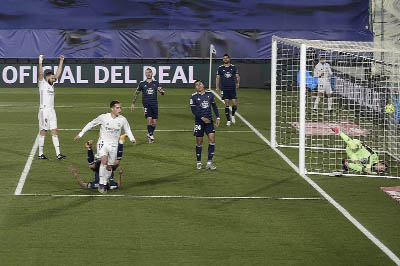 Real Madrid's forward Lucas Vazquez (center) reacts after scoring a goal during the Spanish League football match against Celta Vigo at the Alfredo Di Stefano stadium in Valdebebas, northeast of Madrid on Saturday.