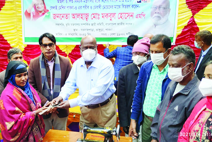 Md. Mokbul Hossain, MP and Chairman of the Standing Committee on Land Ministry distributes sewing machines among poor and meritorious girls in Bhangura Upazila of Pabna district on Monday.