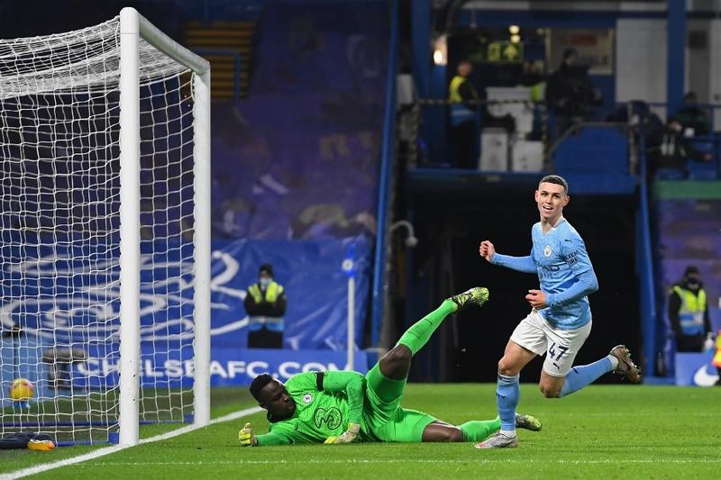Manchester City's midfielder Phil Foden turns to celebrate after scoring their second goal during the English Premier League football match against Chelsea at Stamford Bridge in London on Sunday.