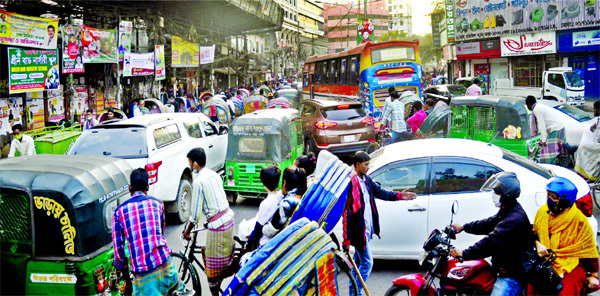Commuters have to face untold sufferings to cross through the Ittefaq Intersection in the capital every day due to rampant violation of traffic rules. This photo taken on Monday afternoon shows that rickshaw pullers enter the road taking wrong side causin