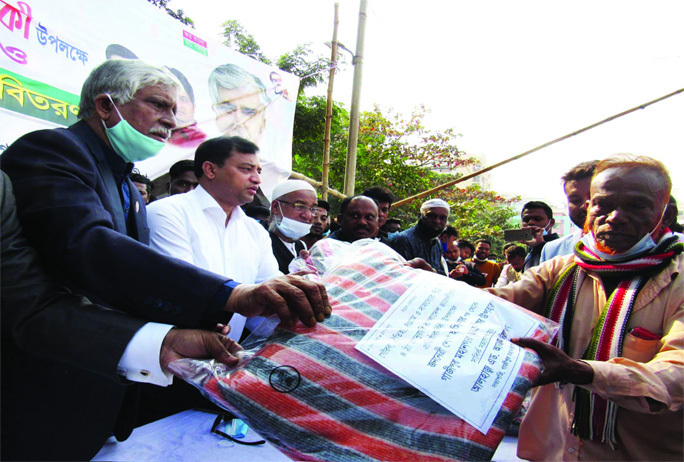 Gazipur City Corporation Mayor Jahangir Alam distributes winter cloths and blanket among the distress people at a ceremony at Tongi government college playground on Tuesday making marking the 73rd founding anniversary of Chhatra League.