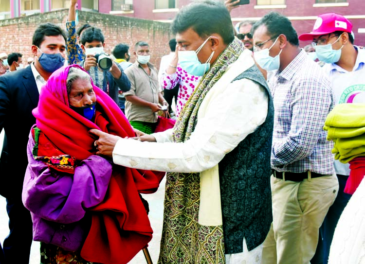 Chairman of the Governing Body of Willes Little Flower School and College and Organising Secretary of the Central Executive Council of Bangladesh Swechchhasebak League Arifur Rahman Titu distributes winter clothes and health materials among the cold-hit