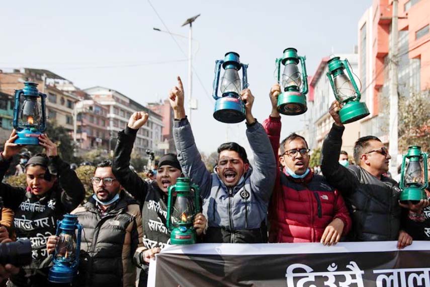 Demonstrators affiliated with a faction of the ruling Nepal Communist Party carry lanterns as they protest against the dissolution of parliament, in Kathmandu, Nepal.