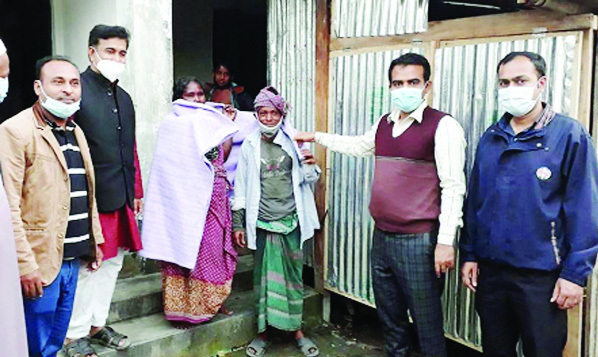 UNO Snehashish Dash distributes blankets among the cold-hit people at Ashrayan Project at Durgapur Dam area in Matlab Uttar Upazila on Tuesday.