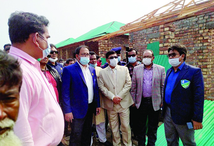 Khulna Deputy Commissioner Mohammad Helal Hossain visits construction of houses to be given to a total of 140 landless and distressed families at Dumuria in the district as a gift from Prime Minister Sheikh Hasina on the occasion of the 'Mujib Borsho'.