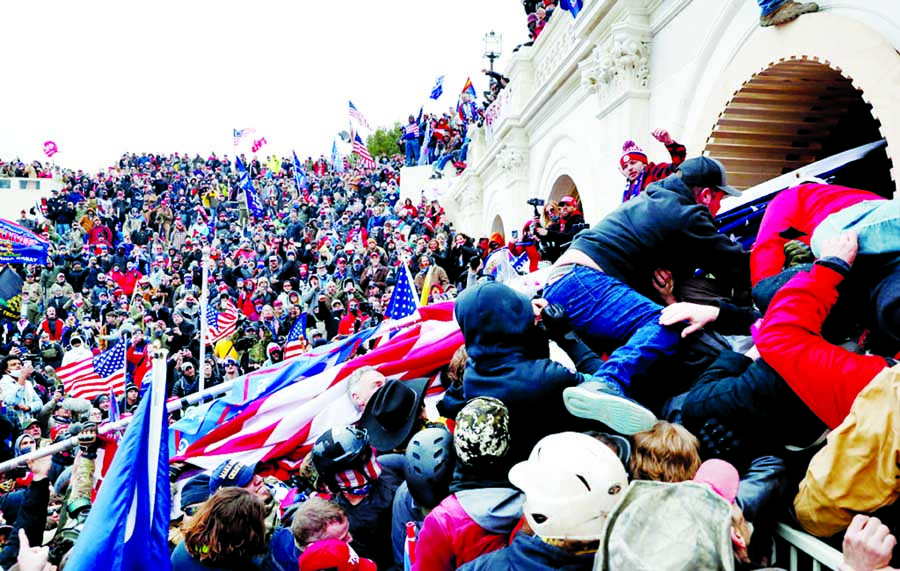 Protesters climb a wall outside the Capitol on Wednesday during a rally in support of President Donald Trump.