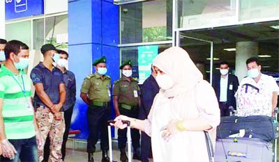UK returnees guided to BRTC buses for institutional quarantine upon their arrival at Sylhet Osmani International Airport from London on Thursday.