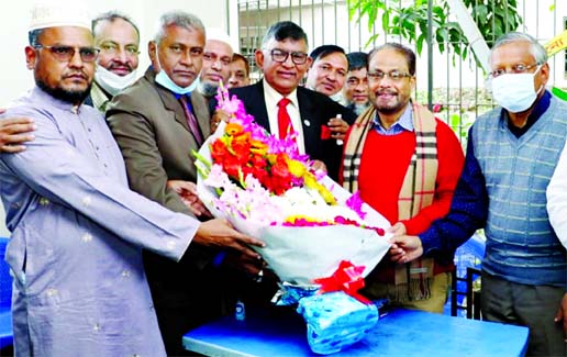 Joint Secretary General of Bikalpadhara Beg Mahtab Uddin joins Jatiya Party giving bouquet to the party Chairman GM Kader, MP at the latter's Uttara residence in the city on Friday.