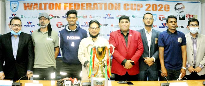 Players, officials of Bashundhara Kings, Saif Sporting Club, the officials of Bangladesh Football Federation (BFF) and the sponsor with the trophy of Walton Federation Cup pose for a photo session at the BFF House on Saturday.