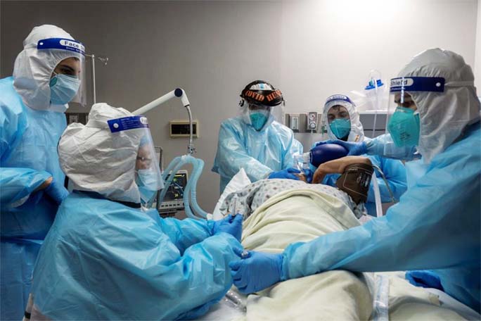 Medical staff members treat a patient suffering from coronavirus in the Covid-19 intensive care unit (ICU) at the United Memorial Medical Center (UMMC), in Houston, Texas on.