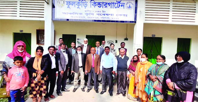 Scientists, experts, officials of Bangladesh Rice Research Institute pose for a photograph after a visiting Fulkuri Kindergarten at Agricultural Research Center at Rahmatpur in Barishal on Saturday.