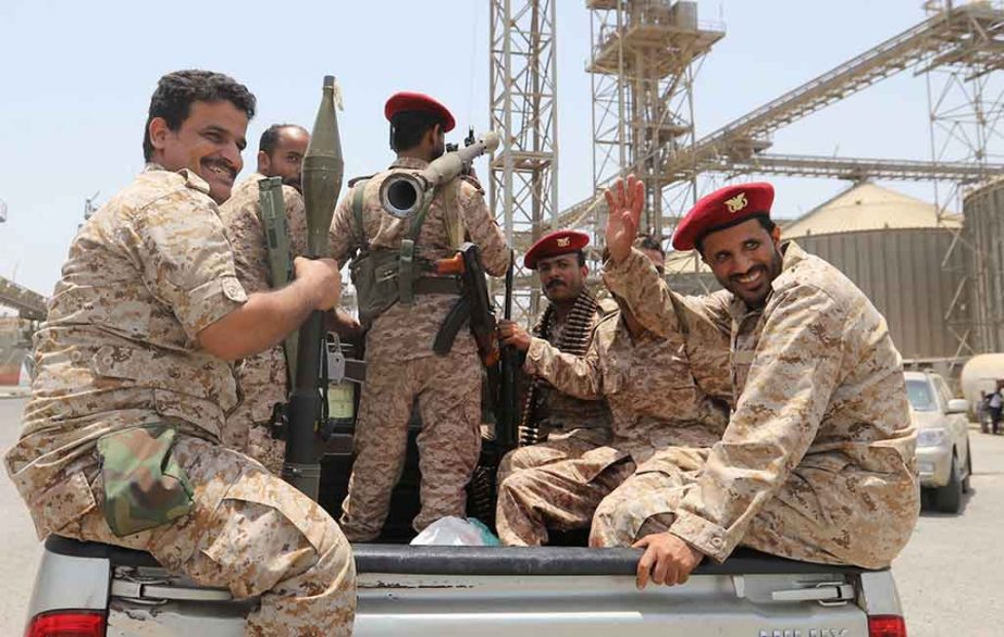 Yemen's Houthi movement forces ride in the back of a vehicle during withdrawal from Saleef port in Hodeidah province, Yemen.
