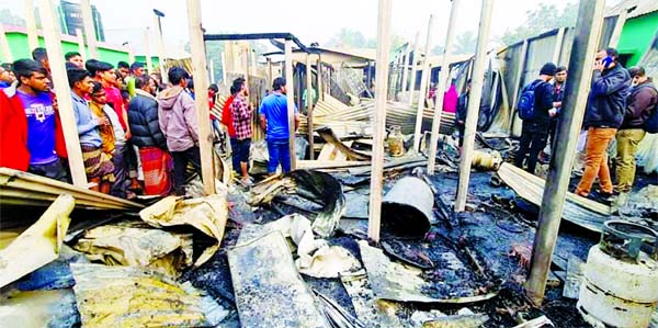 People gather at Kalampur Purbopara Nabboi Colony in Kaliakoir upazila of Gazipur district after a fire broke out there early Monday leaving four people burnt to death.