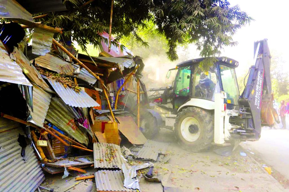Dhaka North City Corporation launches a drive to clear illegal structures on the road in front of the National Institute of Traumatology and Orthopaedic Rehabilitation (NITOR) in Dhaka on Tuesday.