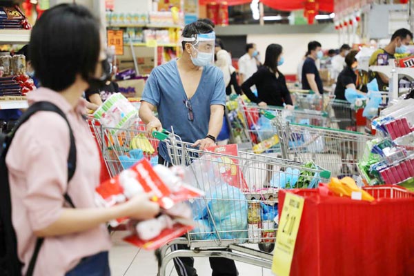 People line up to pay at a supermarket, amid the coronavirus outbreak in Kuala Lumpur, Malaysia on Tuesday.