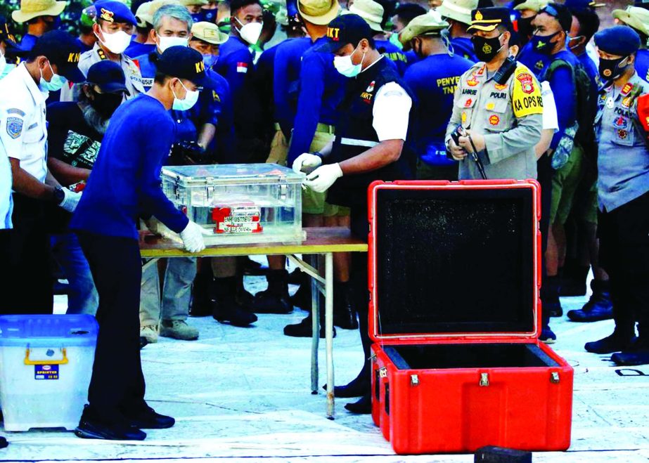 National Transportation Safety Committee (KNKT) officials hold a part of the retrieved black box of Sriwijaya Air flight SJ 182, which crashed into the sea at the weekend off the Jakarta coast, in Jakarta, Indonesia on Tuesday.