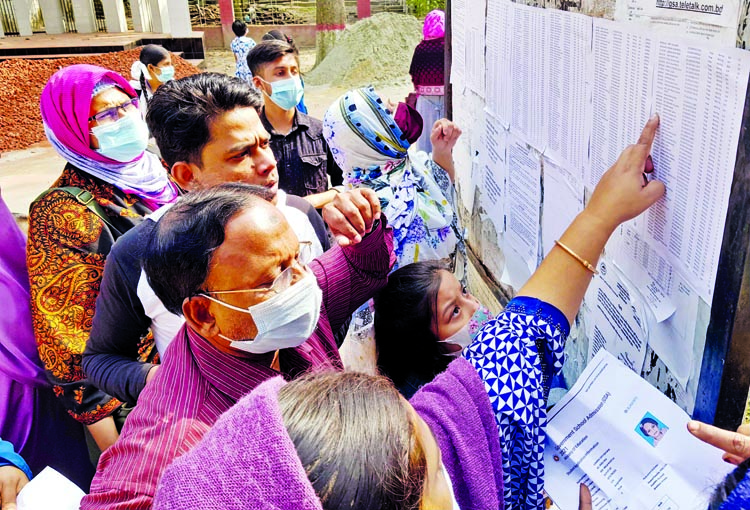 Parents gather in front of the Motijheel Ideal School and College in the capital to check lottery results for admission of their children on Tuesday.