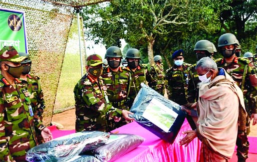 Chief of Army Staff General Aziz Ahmed distributes warm clothes among the helpless and destitute people during his visit to 19 Infantry Division and Ghatail area in Tangail on Tuesday.