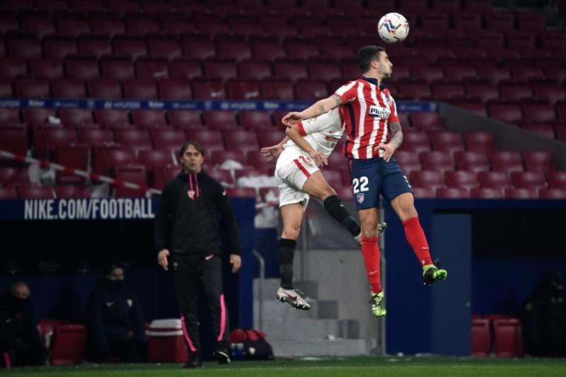 Sevilla's midfielder Jesus Navas (left) vies with Atletico Madrid's defender Mario Hermoso during the Spanish League football match at the Wanda Metropolitano stadium in Madrid on Tuesday.