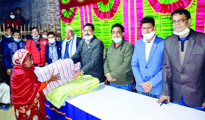 Manoranjan Shil Gopal, MP, distributes blanket among the cold-hit people at Dabor union in Kaharole Upazila of Dinajpur district on Tuesday night.