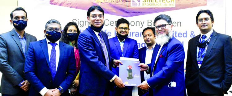 Md Sheikh Rakibul Karim, Acting CEO of Guardian Life Insurance Ltd and Md Mesbah Uddin Khan, CEO of Sheltech Brokerage Limited, exchanging documents after signing an agreement at the GILD head office in the city recently. As per the deal, all the employee