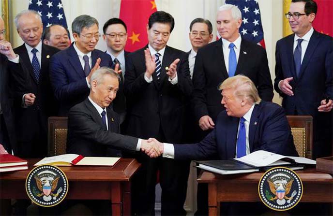 Chinese Vice Premier Liu He and US President Donald Trump shake hands after signing "phase one"of the US-China trade agreement during a ceremony in the East Room of the White House in Washington, US.