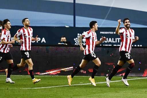 Athletic Bilbao's Raul Garcia (right) celebrates with teammates after scoring the opening goal during Spanish Super Cup semi final soccer match between Real Madrid and Athletic Bilbao at La Rosaleda stadium in Malaga, Spain on Thursday.