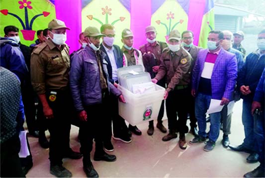 Ansar members carry ballot boxes ahead of Gaibandha municipal polls to be held today.