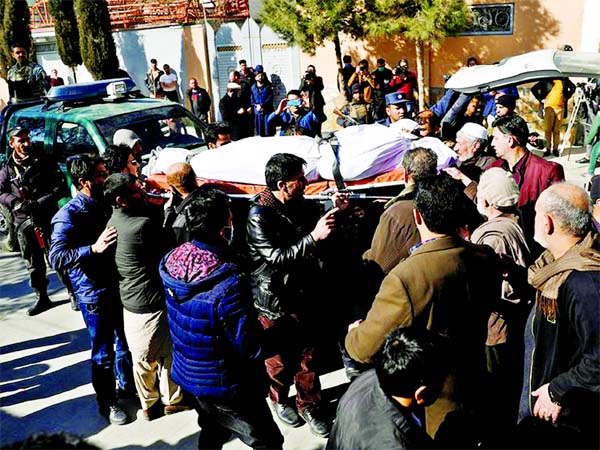 Relatives carry the body of one of the female judges shot dead by unknown gunmen in Kabul on Sunday.