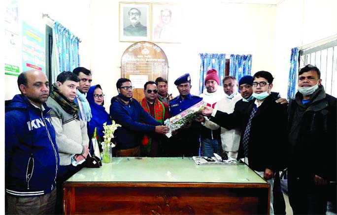 Leaders and activists of Bhasani Parishad greet Md Mosarraf Hossain, in-charge of Kagmari police outpost in Tangail Sadar Upazila, with flower bouquet on Sunday morning for his unique activity to aware people that sons and daughters are all equal.