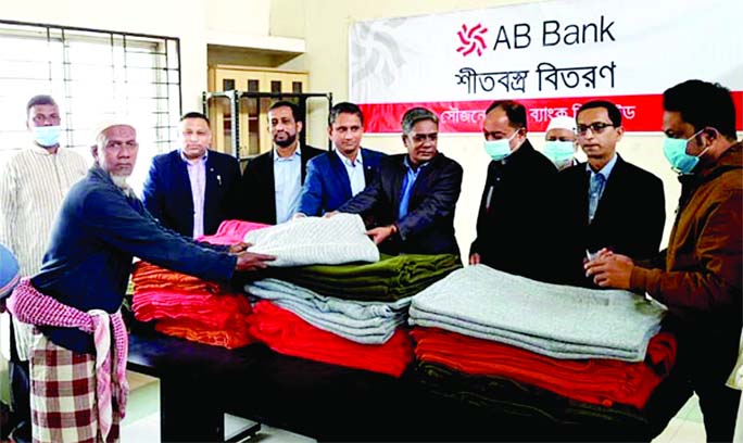 Officials of AB Bank Ltd distribute blankets among the deprived people of Osmaninagar and Balagonj upazila in Sylhet recently.