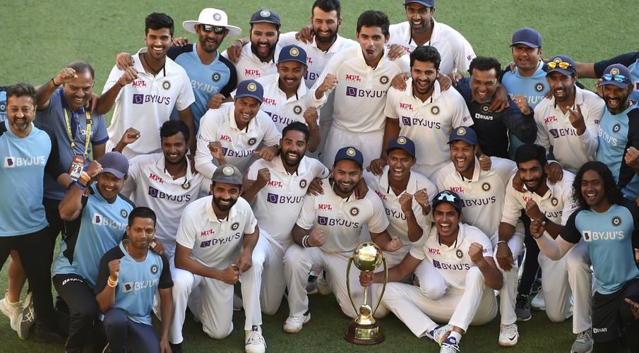 Indian players and officials celebrate with the winning trophy at the end of the fourth cricket Test match between Australia and India at The Gabba on Tuesday.