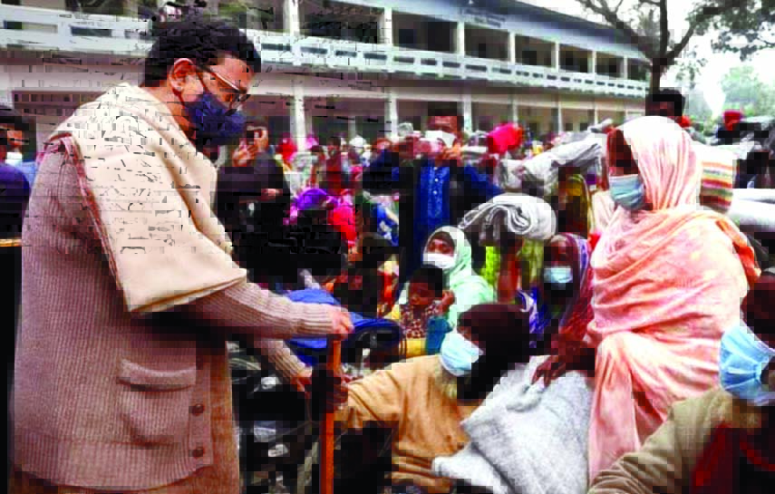 State Minister for Shipping Khalid Mahmud Chowdhury distributes winter clothes among the cold-hit poor people and wheel chairs among the physically handicapped people at a ceremony organised by Biral Upazila Awami League in the auditorium of Biral Upazila
