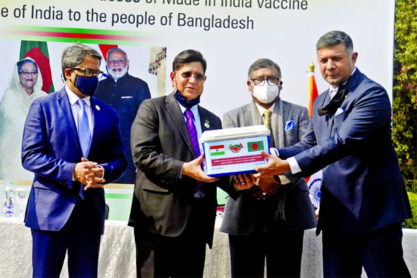 Indian High Commissioner to Bangladesh Vikram Kumar Doraiswami hands over Covid-19 vaccine to Foreign Minister Dr AK Abdul Momen at the State Guest House Padma in the city on Thursday. Health and Family Welfare Minister Zahid Maleque and State Minister fo