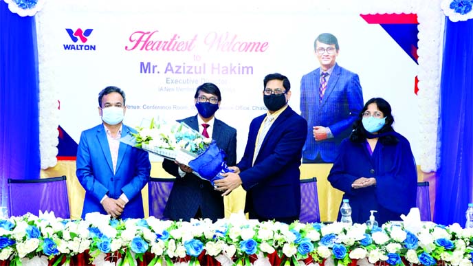 Walton Digi-Tech Industries Limited Chairman SM Rezaul Alam welcomes Azizul Hakim to the company with a flower bouquet.